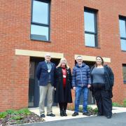 City councillors, from left, Mike Sands and Sue Sands,  Mike Stonard and Beth Jones outside a new home at Three Score