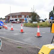 The month-long delay to work at the Heartsease roundabout has been blasted by businesses and councillors alike, inset, as being 