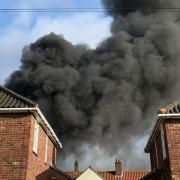 Black smoke is rising over houses near Eaton Park