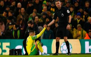 Max Aarons gets a helping hand from Andre Marriner in Norwich City's 4-0 Premier League defeat to Man City