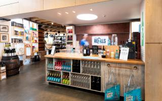 Adnams has introduced refillable beer, wine and gin to four of its high street stores in a drive to continue its sustainable legacy.